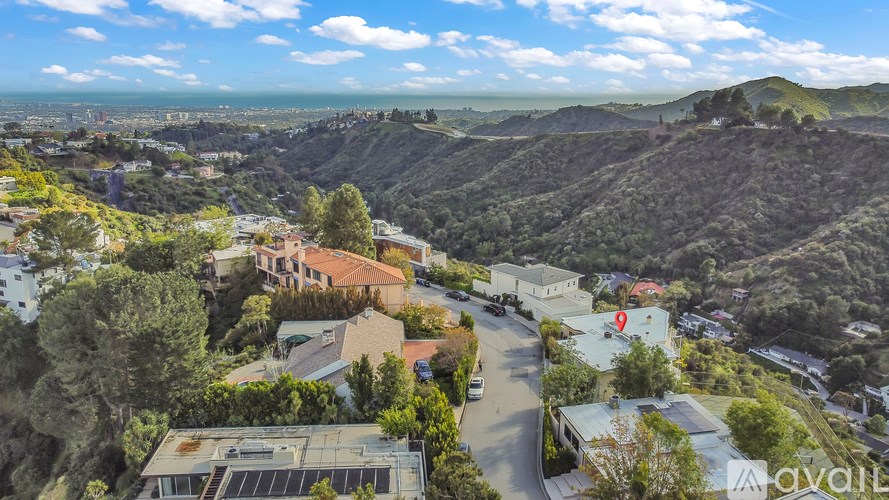 A bird's eye view of a residential area with houses and trees.