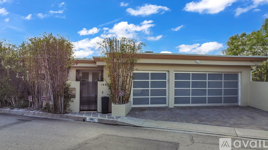 A modern house with a garage is for sale.