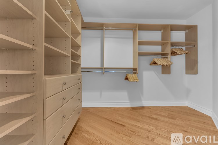 A room with wooden shelves and drawers is available for rent.