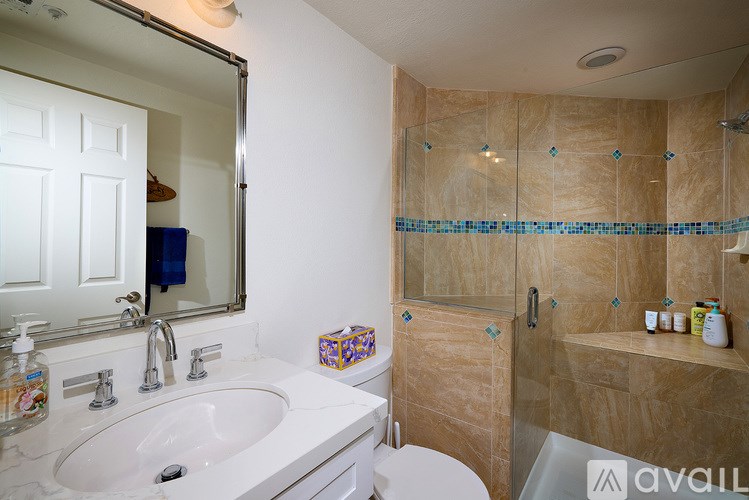 A bathroom with a sink, toilet, and shower.