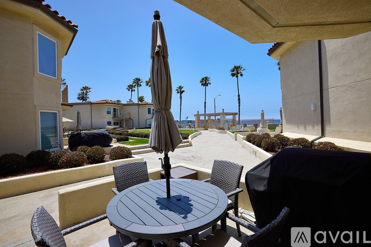 A patio with a table, chairs, and an umbrella is available for rent.