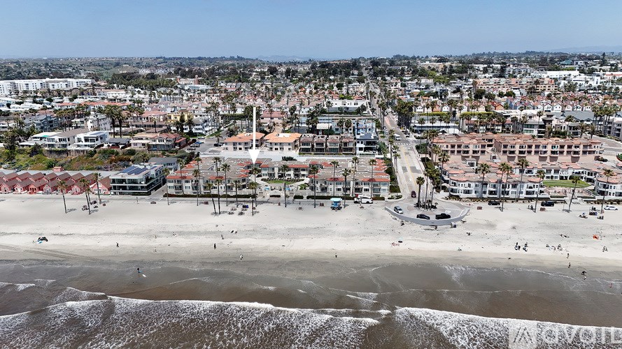 A beachfront city with a sandy beach and buildings.