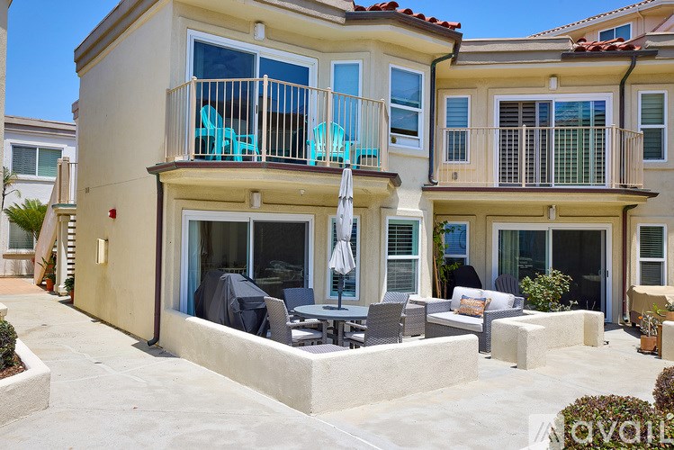 A house with a balcony and patio furniture.