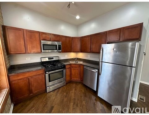 A kitchen with wooden cabinets and stainless steel appliances.