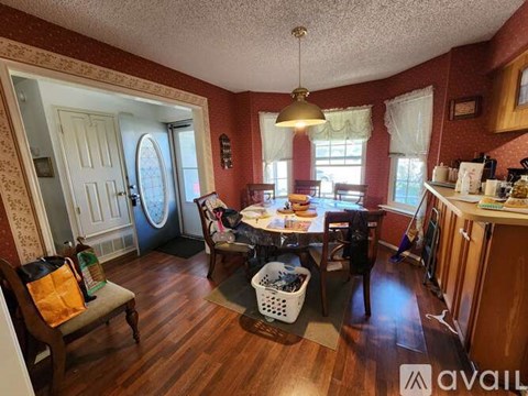A kitchen with a table and chairs in the middle of the room.