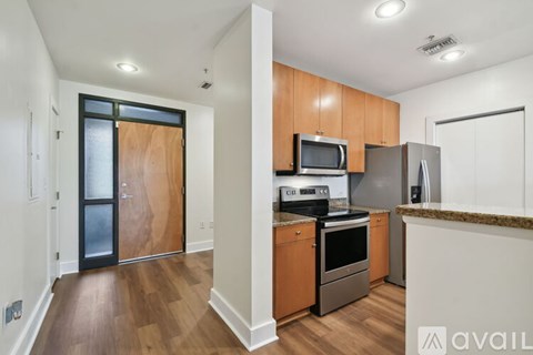 A kitchen with wooden cabinets and a granite countertop.