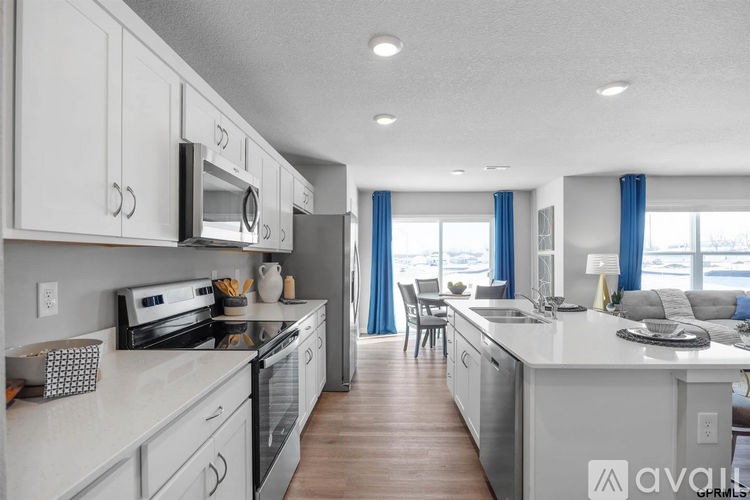 A kitchen with white cabinets and a white countertop.