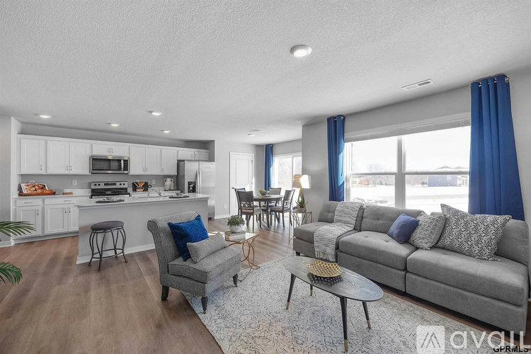 A living room with a grey couch and a coffee table.