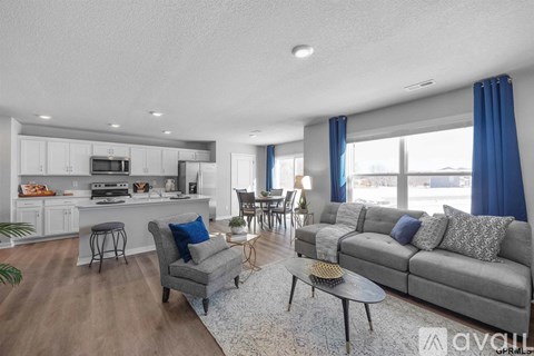 A living room with a grey couch and a coffee table.