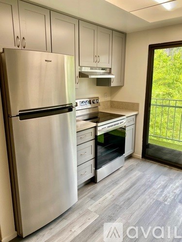 A kitchen with a stainless steel refrigerator and a stainless steel oven.