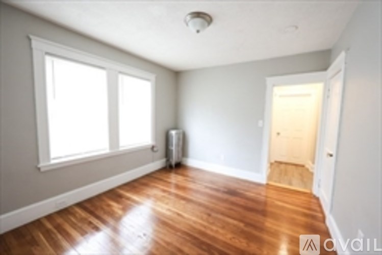 A room with wooden floors and white walls.