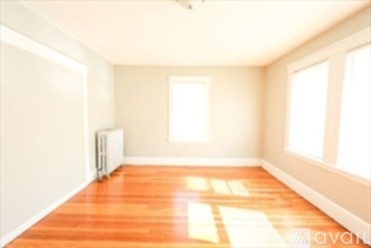 A room with wooden floors and white walls.