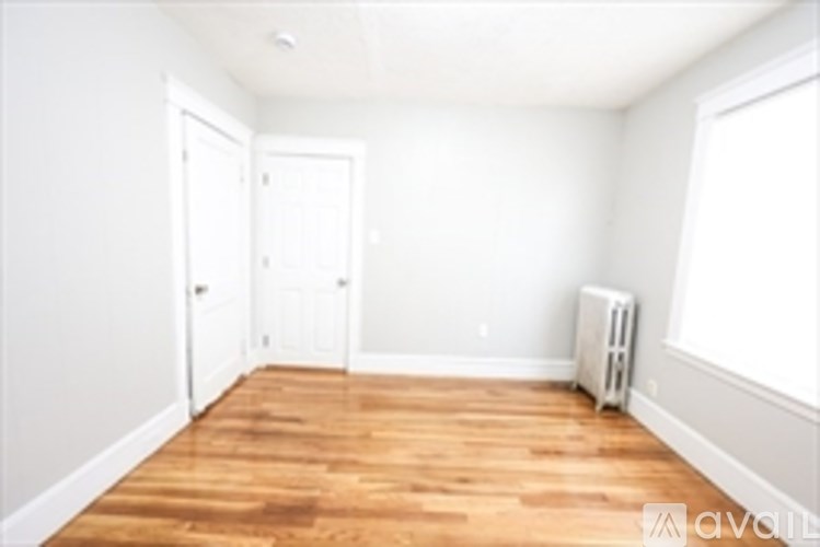 A room with wooden floors and white walls.