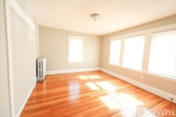 A room with wooden floors and white walls.