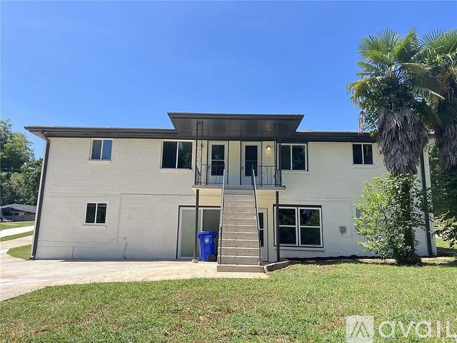 A two-story house with a balcony on the second floor.