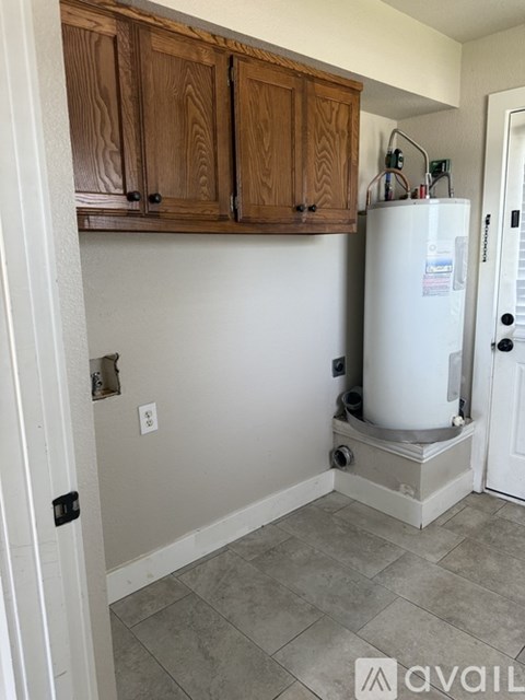 A kitchen with wooden cabinets and a white refrigerator.