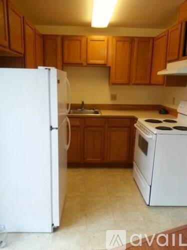 A kitchen with a white refrigerator and a white stove.