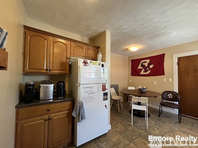 A kitchen with a fridge that has a magnet on it.