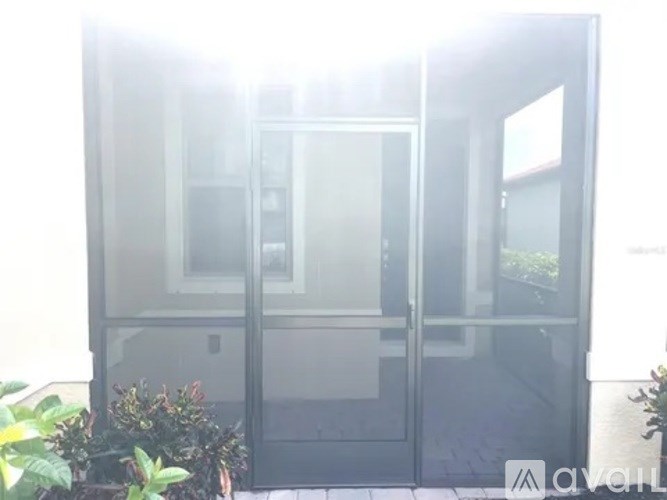A glass door with a metal frame is open.