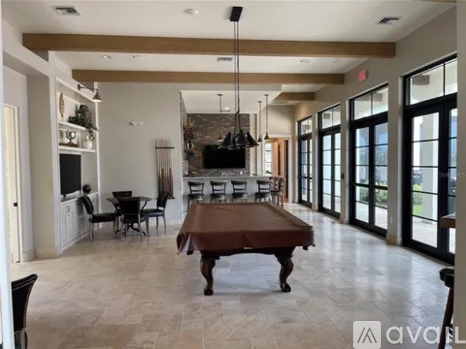 A spacious living room with a large wooden table and a television.