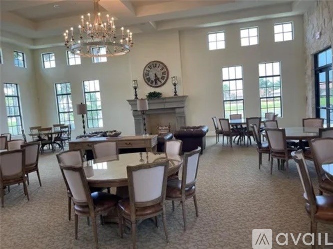 A large room with a fireplace and a chandelier.