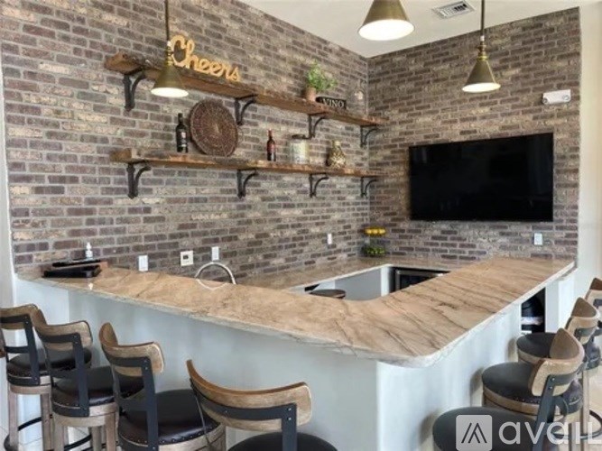 A bar with a brick wall and wooden chairs.