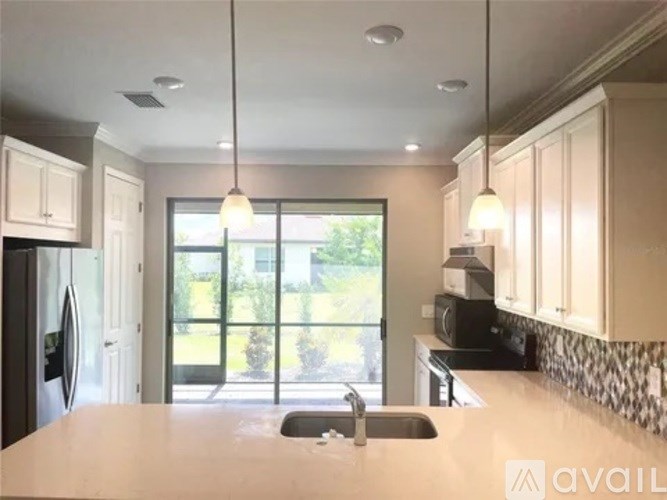 A kitchen with a sink and a window.