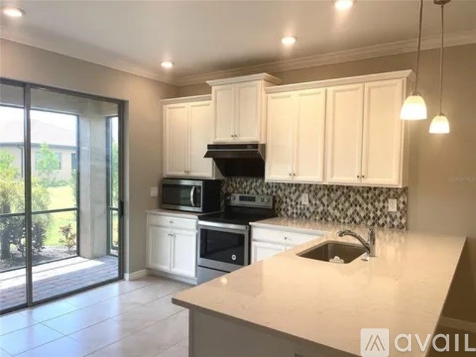 A kitchen with white cabinets and a countertop.