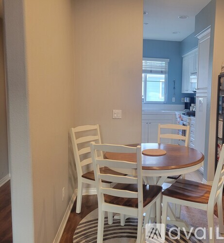 A dining room with a table and chairs.