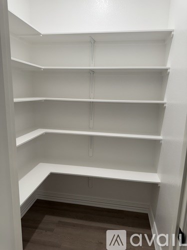 Empty white shelves in a room.