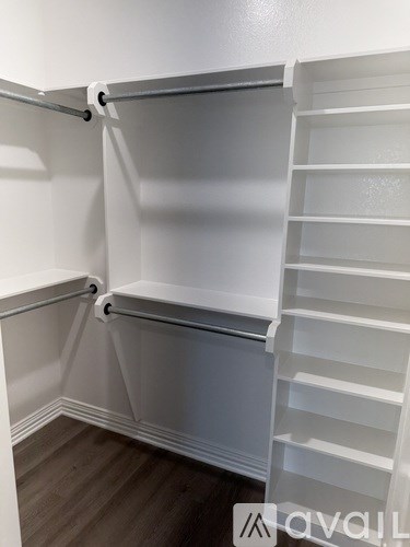 A white closet with shelves and a hanging rod.