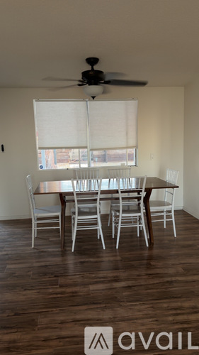 A dining room with a table and chairs.