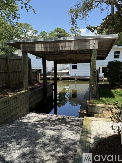 A wooden structure with a pool in front of it.