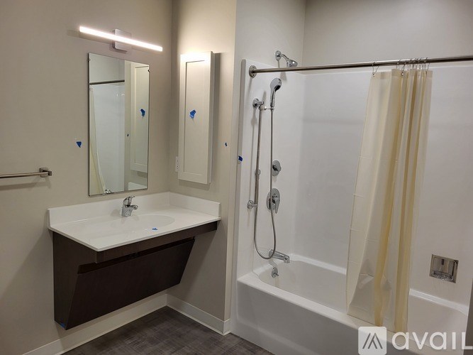 A bathroom with a white sink and a white bathtub.