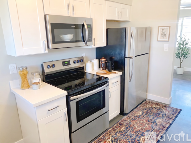 A kitchen with white cabinets and a stainless steel dishwasher.