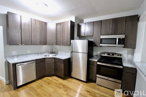 A kitchen with wooden cabinets and stainless steel appliances.