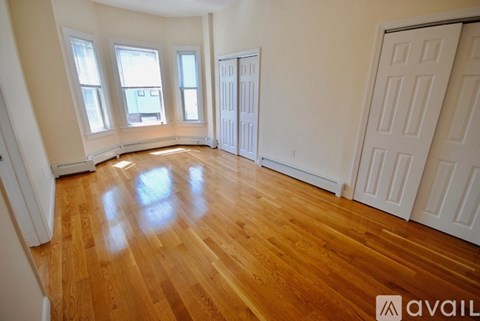 A room with wooden floors and white walls.