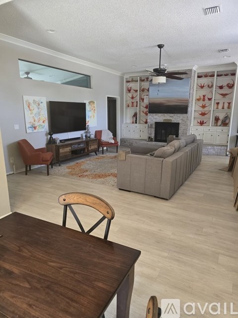 A living room with a fireplace and a television.