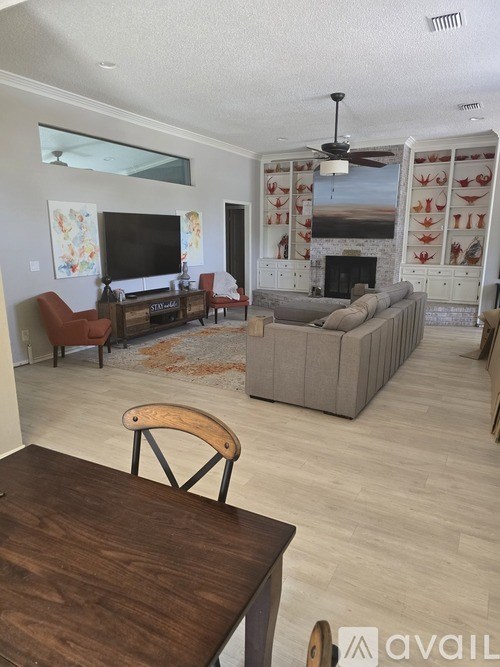 A living room with a fireplace and a television.