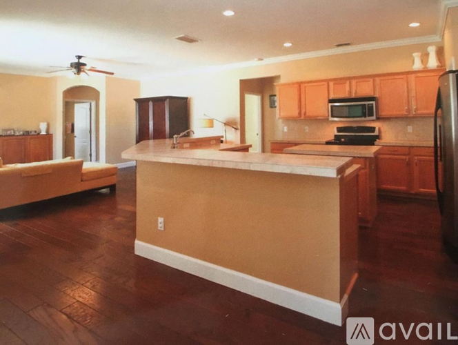 A kitchen with wooden floors and a large island.