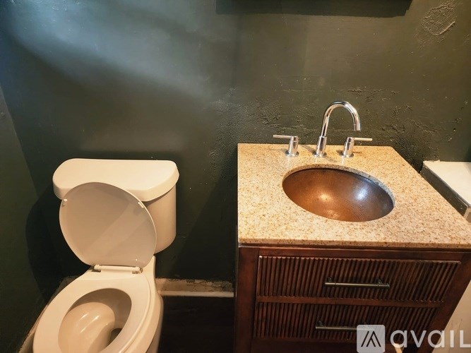 A toilet and sink in a bathroom.