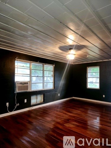 A room with wooden floors and a white ceiling.