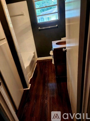 A small bathroom with a toilet and a window.