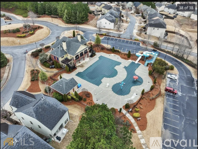 A bird's eye view of a residential area with a swimming pool and a playground.
