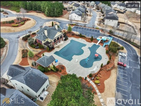 A bird's eye view of a residential area with a swimming pool and a playground.