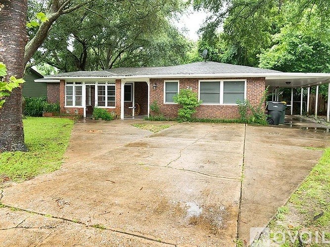 A house with a driveway in front of it.