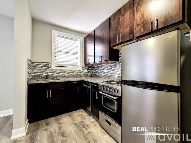 A kitchen with a stainless steel refrigerator, oven, and backsplash.