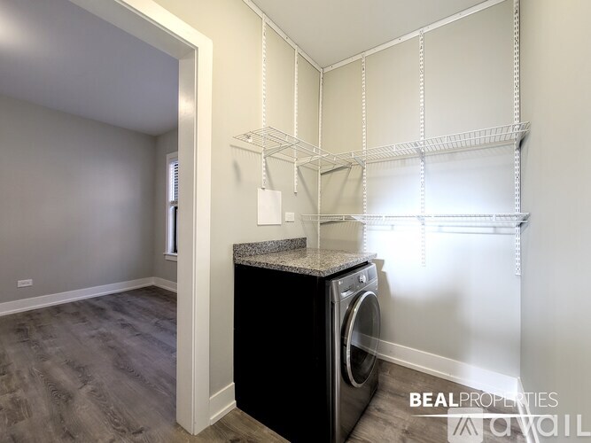 A laundry room with a washer and dryer in it.