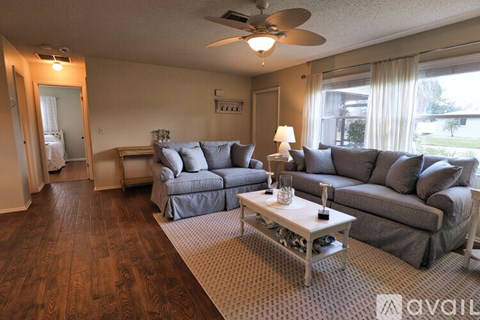 A living room with a grey couch and a coffee table.