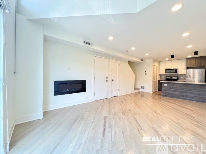 A kitchen with a black stove top oven and a microwave above it.